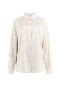 Blouse rose clair à manches longues, col boutonné et embellissements en motif de feuilles. Texture lisse et tissu légèrement opaque.