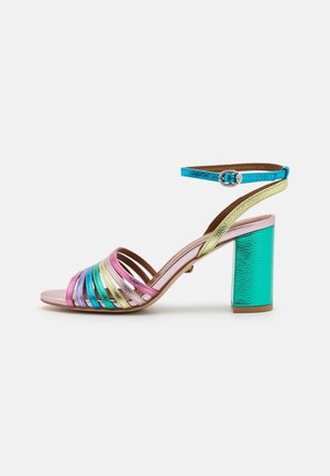 Strappy high-heeled sandal featuring multicolored metallic stripes, a blue ankle strap, and a reflective turquoise block heel.