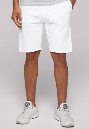 Pantalones cortos deportivos blancos hechos de una mezcla de algodón, con bolsillos laterales, una cinturilla elástica con cordón y un dobladillo recto.