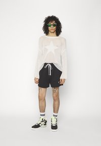 Nike Sportswear FT FLOW - Pantalon de survêtement - black/white