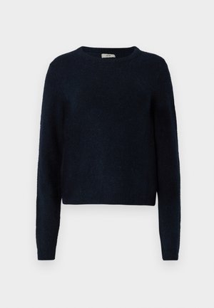 Pull en laine bleu marine avec des manches longues, col rond et tissu texturé. Il présente une coupe décontractée et des poignets et un ourlet côtelés.