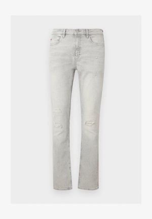 Jean slim gris clair avec usure aux deux genoux, cinq poches, fermeture par bouton et zip.