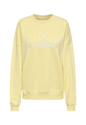 Sweat-shirt jaune avec "LA SUPERBE" brodé en blanc. Coupe standard avec manches longues et col rond. Matière en coton doux.