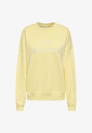 Yellow sweatshirt featuring "LA SUPERBE" embroidered in white. Standard fit with long sleeves and a round neckline. Soft cotton material.