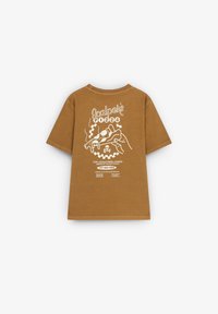 Brown cotton t-shirt featuring a white graphic design on the back, including pizza imagery and text, with a relaxed fit and short sleeves.
