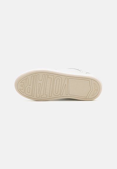 Shoe sole in light beige rubber, featuring a bold embossed "VOLTARE" logo and textured surface for traction. Rounded heel and smooth edges.