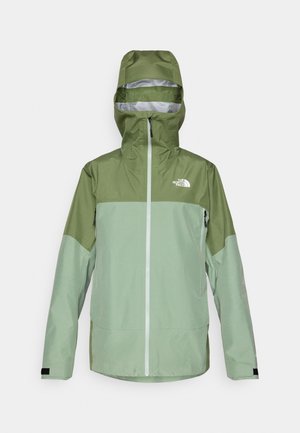 Vihreä vedenpitävä takki hupulla, jossa on kaksivärinen muotoilu, etuvetoketju ja logo vasemmassa ylärinnassa. Teksturoidun kankaan pinta.