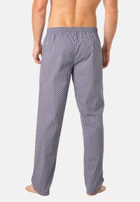 Pantalons de pyjama pour hommes avec un motif circulaire bleu marine et blanc, taille élastique, coupe décontractée et tissu léger.