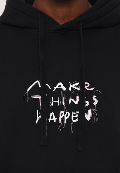 Black cotton hoodie featuring a front graphic that reads "MAKE THINGS HAPPEN" in white and pastel stitching, with visible loose threads.