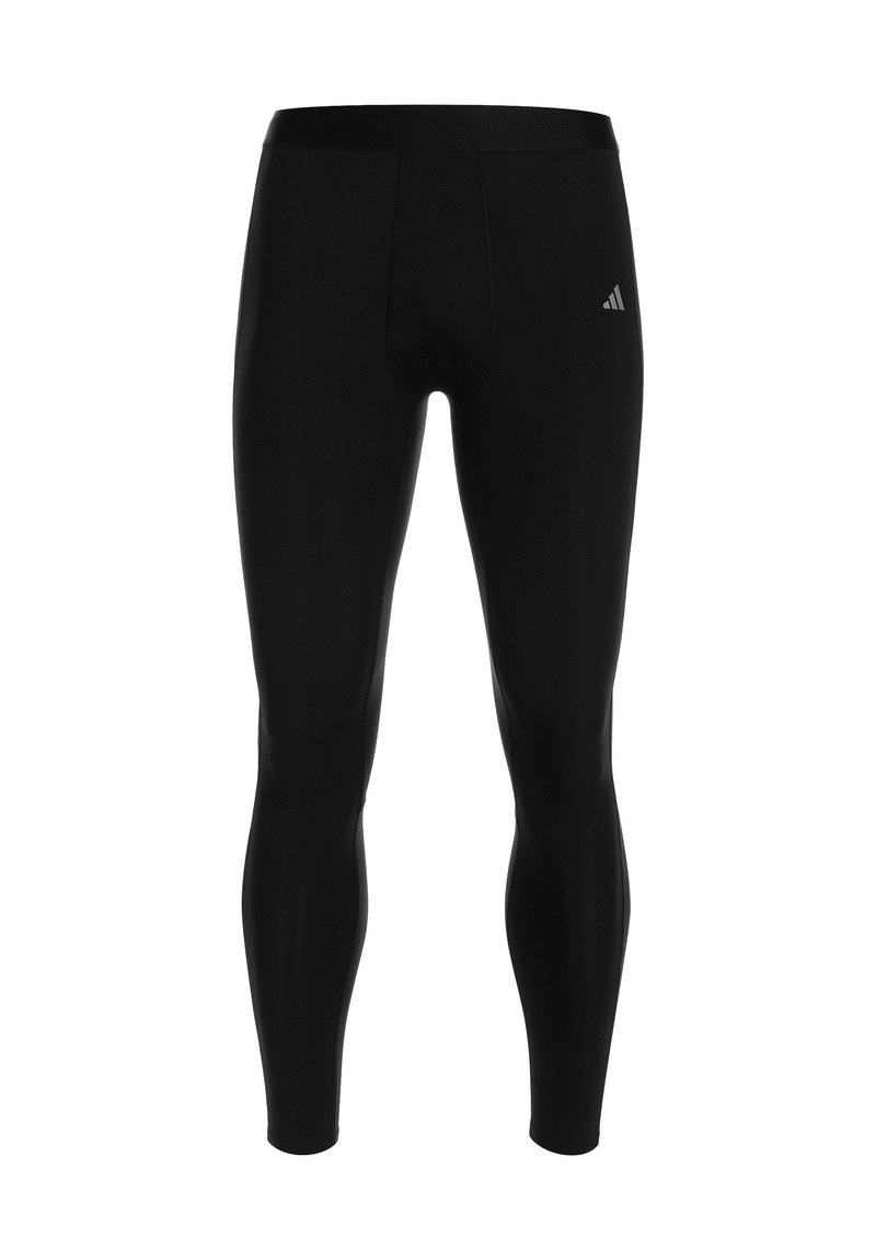 Pantalons de sport noirs en tissu extensible avec une coupe ajustée, dotés d'une taille sans coutures et d'un petit logo sur la cuisse.