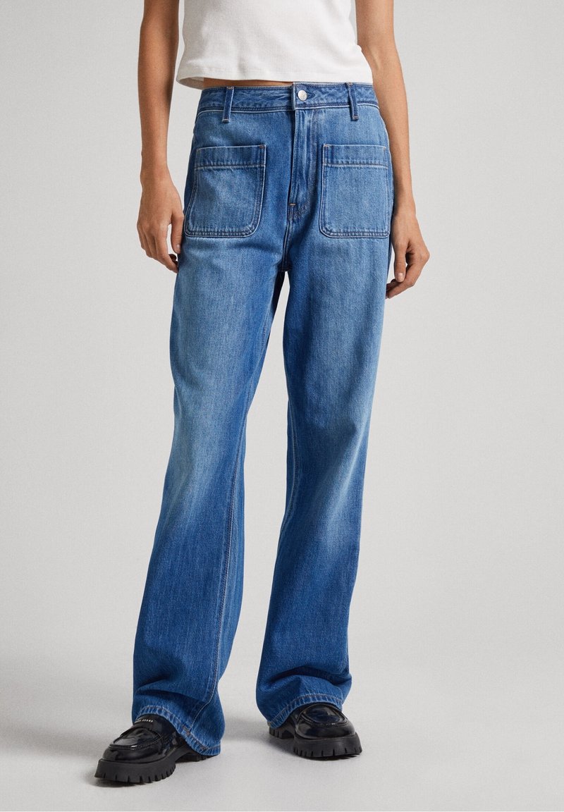 Wide-leg jeans in light blue denim, featuring two large back pockets and subtle fading. Finished with a button closure and belt loops.