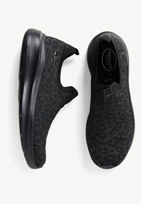 Black slip-on sneakers with a textured, patterned knit upper. Feature a thick, cushioned black sole and a wide fit. Size 37 displayed inside.