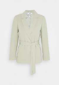 Ljusgrön skräddarsydd kavaj med kiltkrage, långa ärmar och ett knytbart bälte i midjan. Slät tyg utan synliga mönster eller dekorationer.