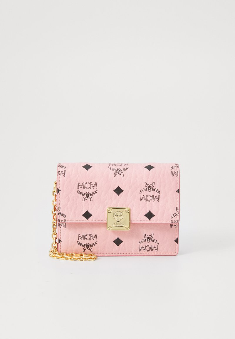 Pink leather wallet with chain strap, featuring a diamond pattern and MCM logos. Gold hardware accents enhance the design.