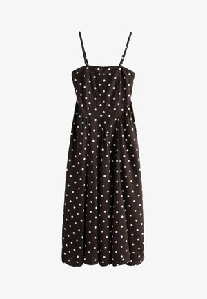 Ruda be rankovių suknelė su baltais tašk mais. Turi prigludusį liemenį, surinktą sijoną ir plonas reguliuojamas petnešas. Pagaminta iš medvilnės.