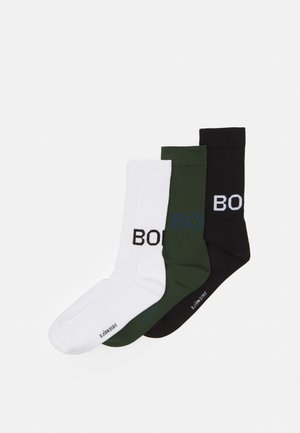 Three pairs of crew socks in white, olive green, and black, featuring a ribbed texture and bold "BOB" lettering in contrasting colors.