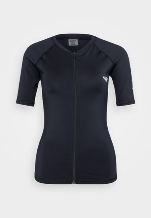 Marineblå rash guard med korte ermer og glidelås foran, laget av strekkbart materiale. Har en glatt tekstur og en liten logo på brystet.