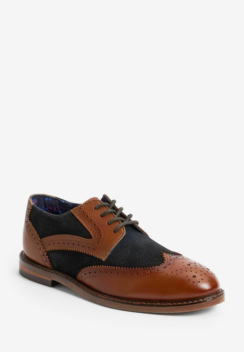 Brun læder- og sort ruskinds dress sko med brogue-detaljer, rund tå og snørebåndsdesign. Har et mønstret inderskift.