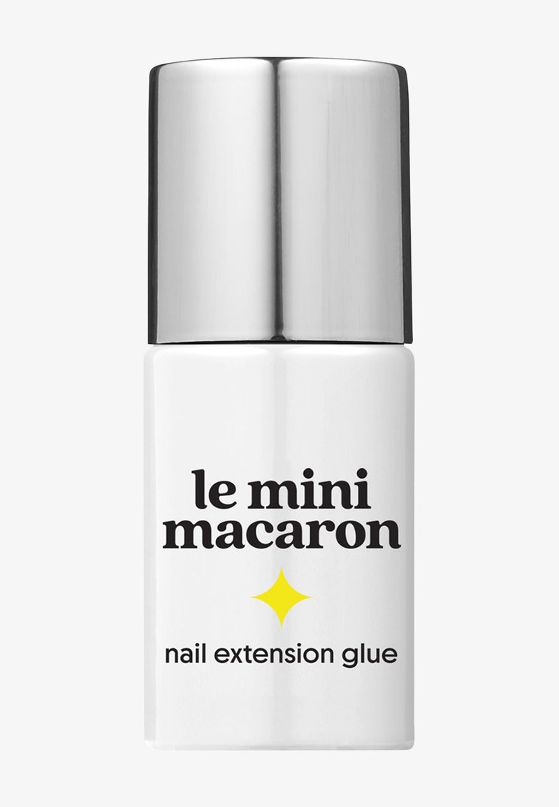 Bouteille blanche de colle pour extension d'ongles Le Mini Macaron avec un bouchon argenté brillant et une icône d'étoile jaune sur l'étiquette.