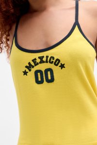 Yellow cotton tank top with navy blue trim, featuring black embroidery reading "MEXICO" and the number "00" with green accents.