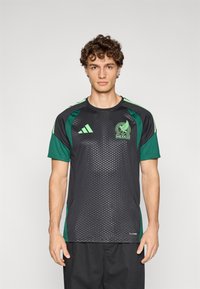 Black and green short-sleeve soccer jersey with a textured pattern, featuring a Mexico logo and Adidas branding on the chest and shoulders.