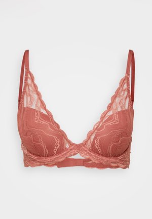 Bralette en dentelle de couleur rose doux avec des bords festonnés, un soutien-gorge à armatures et des bretelles réglables. Présentant des motifs floraux complexes.