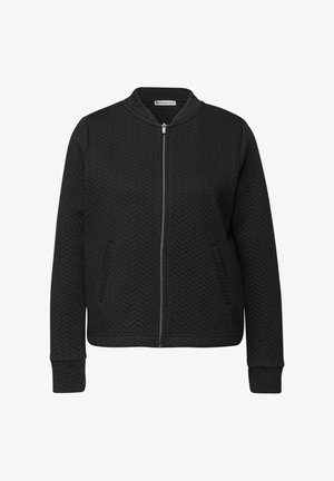 Sort bomberjakke med et struktureret fiskebenmønster, lynlåslukning, sidelommer og ribstrikkede ærmekanter og kant. Fremstillet af et blødt stof.
