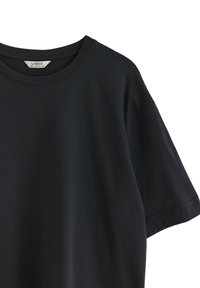 Black cotton T-shirt with a round neckline and short sleeves. Smooth texture with minimal seams and no visible patterns. Brand label appears inside.