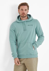 Light blue hooded sweatshirt with a front pocket. Features drawstrings and a small logo that reads "EBB & FLOW" on the chest. Soft texture.