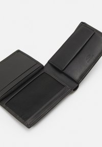 Black leather wallet with a smooth texture, features a card slot, and a mesh section, designed in a bifold style.