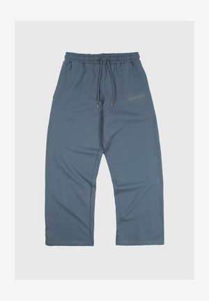 Loose-fitting blue-gray sweatpants with elastic waistband and drawstrings, featuring subtle text detail on the upper thigh.