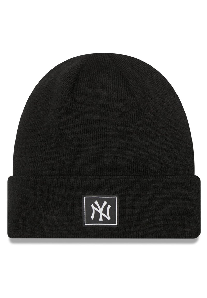 Black knitted beanie with a folded cuff, features a white rectangular logo patch with a stylized "NY" in the center. Smooth texture.