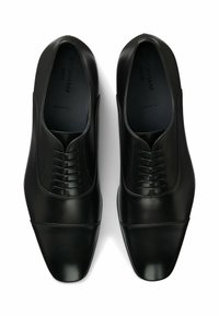 Black leather dress shoes with a sleek design, pointed toe, and stitched detailing. Features a five-eye lace closure and smooth texture.