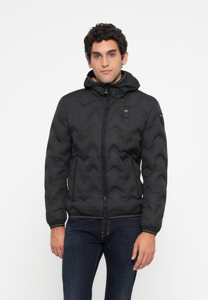 Black quilted puffer jacket with a hood, featuring a front zipper, side pockets, and ribbed cuffs. Logo patch on upper left chest.