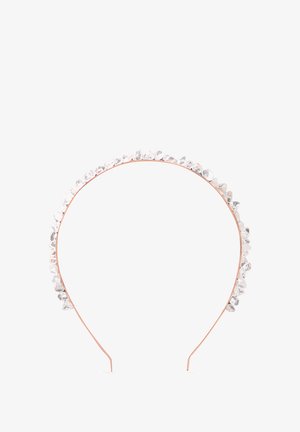 Cerchietto trasparente in cristallo con struttura in filo di rame, decorato con gemme di forma irregolare lungo il bordo superiore. Superficie lucida e riflettente.