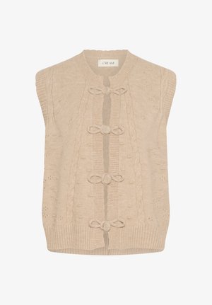 Kreemja värvi soonikkoesereketa ilma varrukateta vest, millel on kaabelmuster ja neli dekoratiivset silmust ning nööbid esiosas.