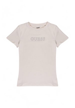 Lichtbeige t-shirt gemaakt van zachte katoen. Geribbelde ronde halslijn, korte mouwen, met het 'GUESS' logo in zilveren studs gecentreerd op de borst.