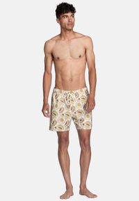 Zwemshorts van een lichte stof met een zon- en ventilatorpatroon in aardetinten, elastische tailleband met een trekkoord en zijzakken.