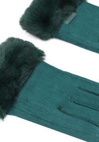 Guanti color teal realizzati in un tessuto morbido con un polsino in pelliccia morbida. Tra le caratteristiche ci sono dettagli cuciti e un'etichetta interna per informazioni su taglia o marca.