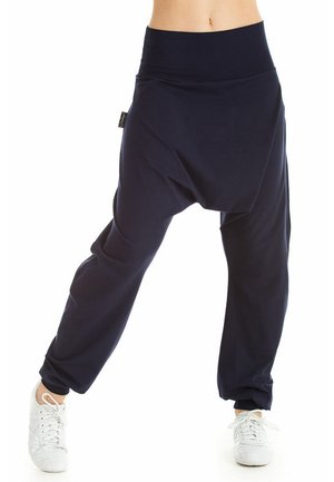 Navy blue drop-crotch pants with a wide, stretchy waistband. Made from soft fabric with a smooth texture and tapered cuffs.