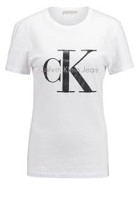 Vit bomull t-shirt med en djärv svart "CK" logotyp och texten "Calvin Klein Jeans". Korta ärmar och en klassisk crew neck-design.