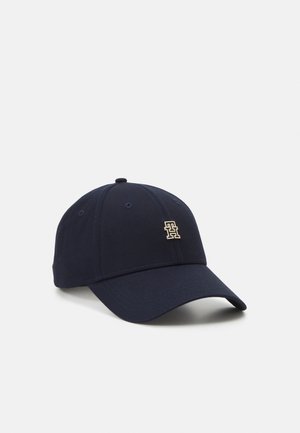 Navy blue baseball cap with curved brim and small metallic logo on front panel, shown against plain light background.