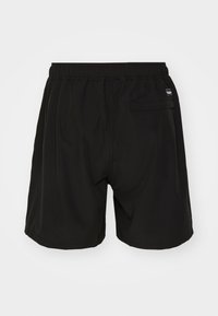 Black swim shorts made from lightweight, quick-drying fabric. Features an elastic waistband and a rear pocket with a flap.