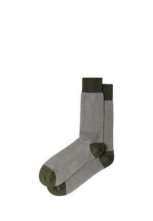 Pair of mid-calf socks in light gray with olive green cuffs, heels, and toes, laid flat against a white background.