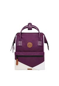Purple canvas backpack with dual handles, front zip pocket, white triangular design accents, and circular logo on leather patch.