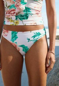 Bloemen bikini-set met een witte achtergrond en roze en groene botanischeprints. Zachte, rekbare stof met een hoge taille ontwerp.