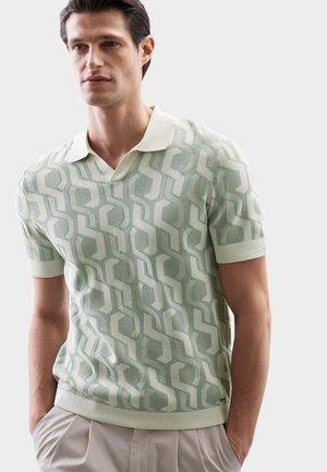Light green knitted polo shirt featuring a geometric pattern, short sleeves, and a contrast collar. Soft texture and fitted design.