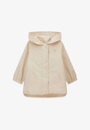Imperméable beige à capuche avec boutons-pression à l'avant, manches longues avec poignets élastiques, deux poches avant et un petit logo en forme de cœur sur la poitrine.