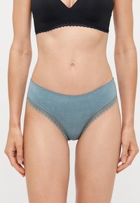 Light blue women's underwear with delicate scalloped lace trim, featuring a smooth texture and a mid-rise fit.