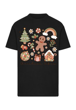 Black t-shirt featuring festive graphics: a Christmas tree, gingerbread man, candy canes, and gifts in pastel colors with a "Christmas Vibes" text.